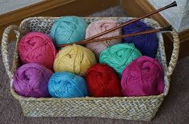 Colorful balls of yarn in a wicker basket