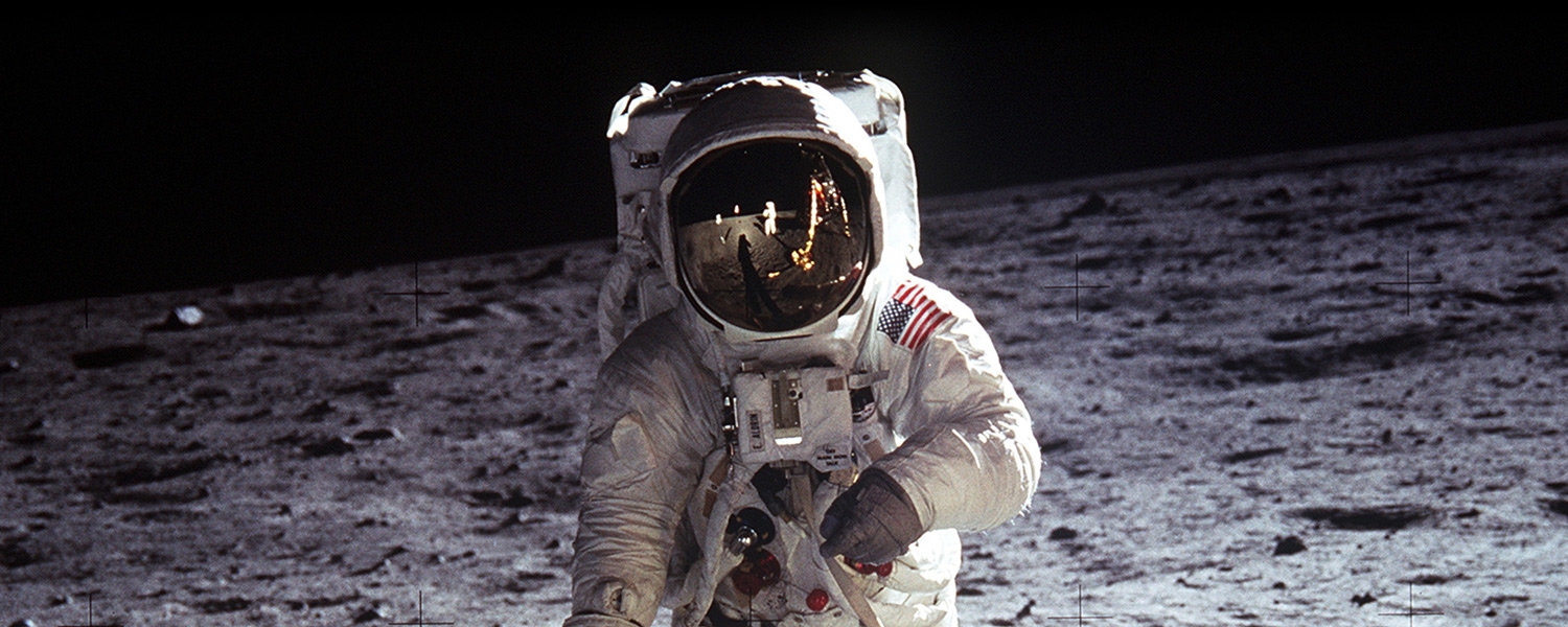 Color picture of an astronaut in a spacesuit on the surface of the Moon