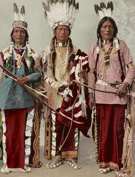 recolorized photo of three Apache men