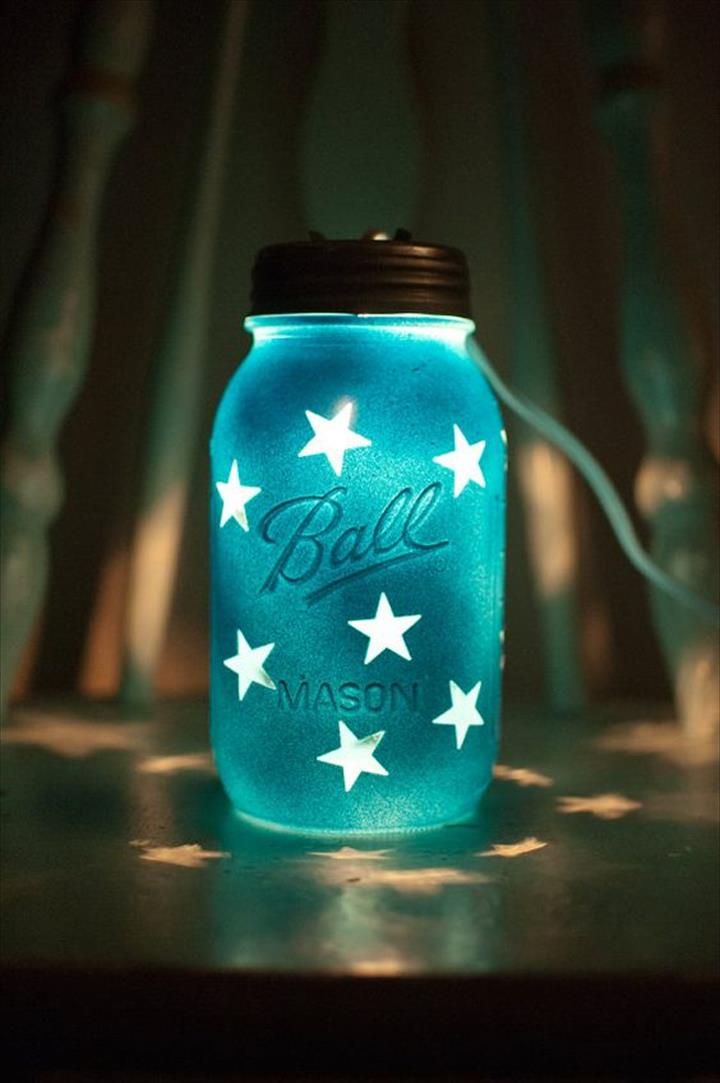 photo of a mason jar decorated with stars and small lights inside