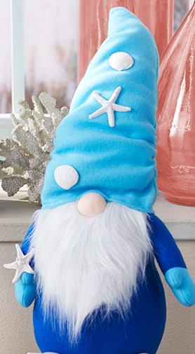 photo of a crafted gnome wearing a blue hat with seashells on it. summer gnome.