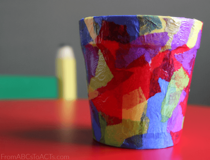 flower pot decorated with tissue paper pieces to make a colorful mosaic