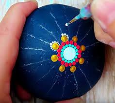 Picture of a simple mandala stone being dotted in design