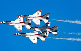 4 jets in formation streaking across a blue sky