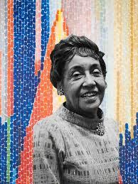 Artist Alma Thomas in front of one of her colorful works of art