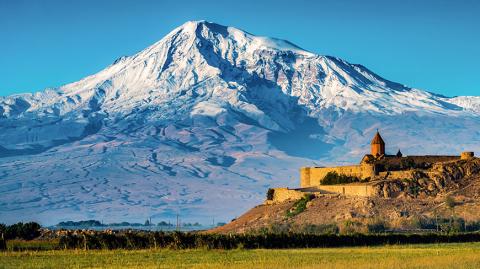 picture of middle eastern castle with snow covered mountain