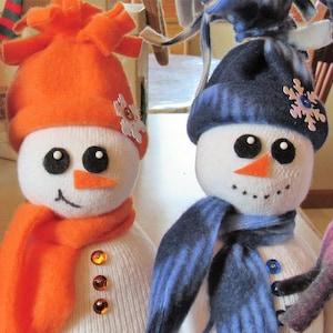 two snowmen crafted out of socks with hats and scarves