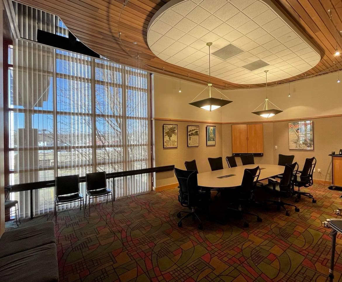 Photo of Boardroom including a conference table, 9 chairs around it and additional seating off to the side