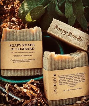 photo of three bars of soap wrapped in Soapy Roads paper packaging