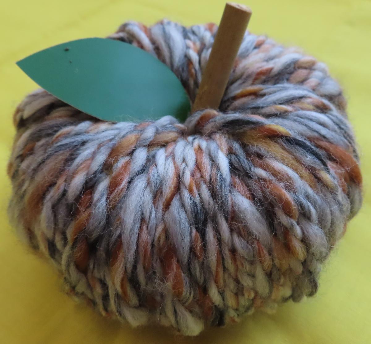 yarn pumpkin with green paper leaf